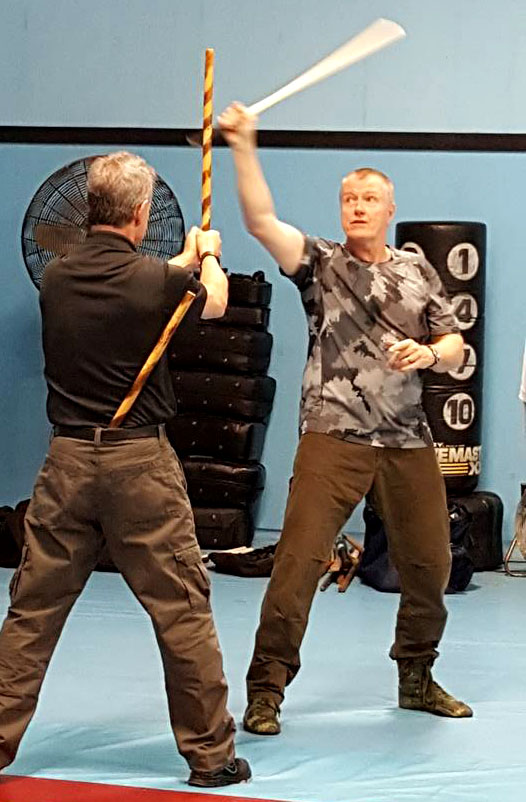 two men sparring with Filipino stick fighting martial arts Stock Photo